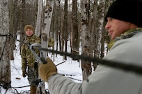 Sgt. 1st Class Alex Bouteiller, left, a student at the U.S. Army Mountain Warfare School’s Basic Military Mountaineer Course, sets up a casualty evacuation system Jan. 22, 2022.