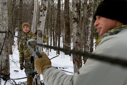 Sgt. 1st Class Alex Bouteiller, left, a student at the U.S. Army Mountain Warfare School’s Basic Military Mountaineer Course, sets up a casualty evacuation system Jan. 22, 2022.