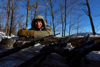 Staff Sgt. Tim McLaughlin, an instructor at the U.S. Army Mountain Warfare School, at a high-angle shooting range during the school’s Basic Military Mountaineer Course Jan. 23, 2022. The AMWS is a U.S. Army Training and Doctrine Command school operated by the Vermont Army National Guard at Camp Ethan Allen Training Site, Vermont.