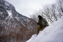 A student at the U.S. Army Mountain Warfare School’s Advanced Military Mountaineer Course uses a locator beacon to find a simulated casualty during avalanche rescue training Jan. 25, 2022. The AMWS is a U.S. Army Training and Doctrine Command school operated by the Vermont Army National Guard at Camp Ethan Allen Training Site, Vermont.