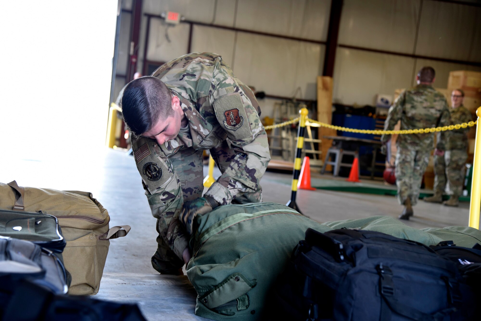 Members of the traffic management office prepare pallets for deployment while taking part in a full-scale readiness exercise June 3-6, 2021