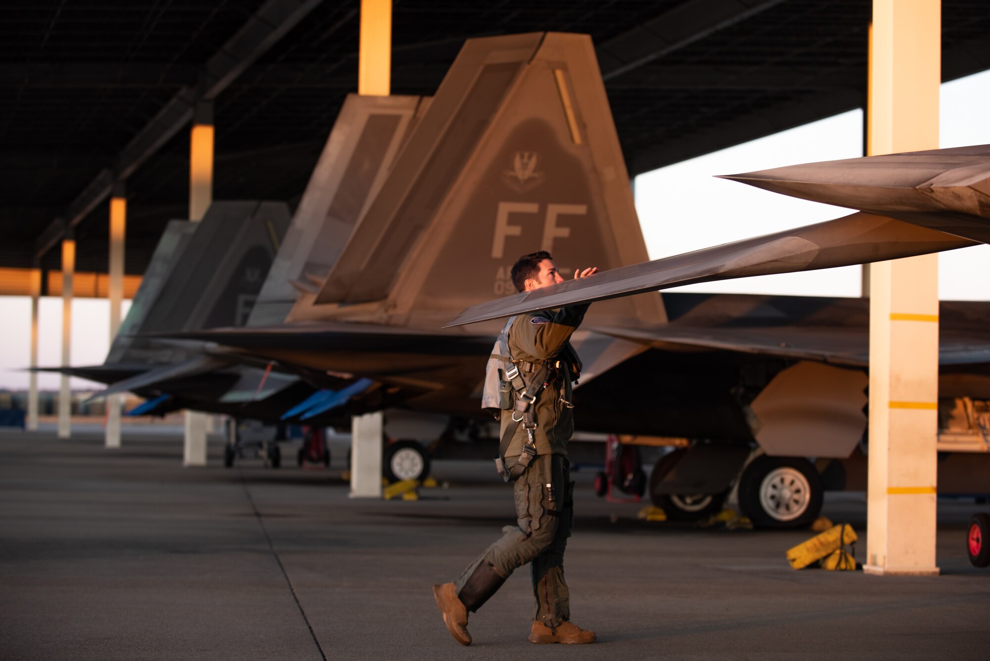 U.S. Air Force Maj. Josh Gunderson, F-22 Raptor Demonstration Team commander and pilot, performs a pre-flight walk-around at Joint Base Langley-Eustis, Va., Jan. 22, 2020.