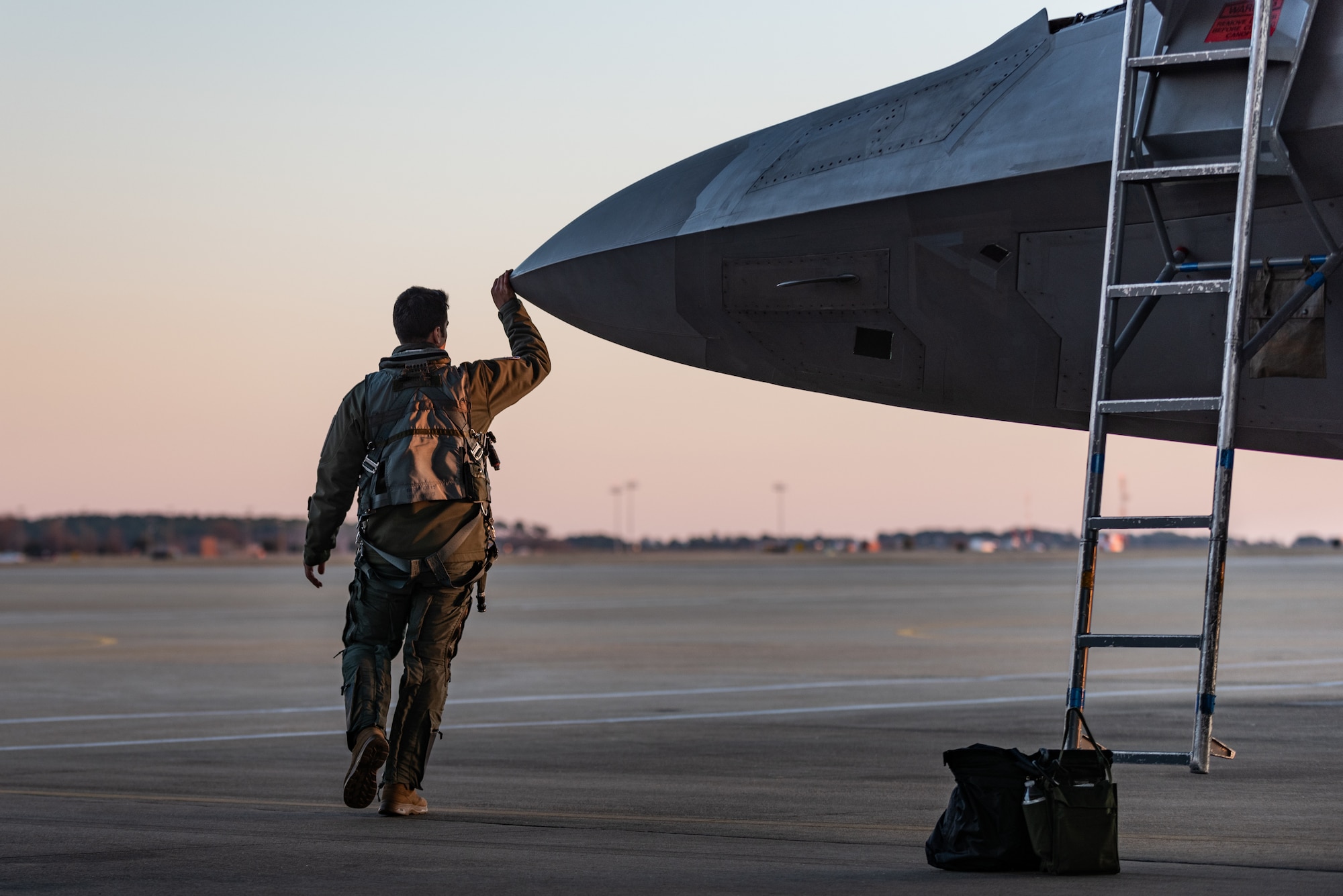 U.S. Air Force Maj. Josh Gunderson, F-22 Raptor Demonstration Team commander and pilot, performs a pre-flight walk-around at Joint Base Langley-Eustis, Va., Jan. 22, 2020.