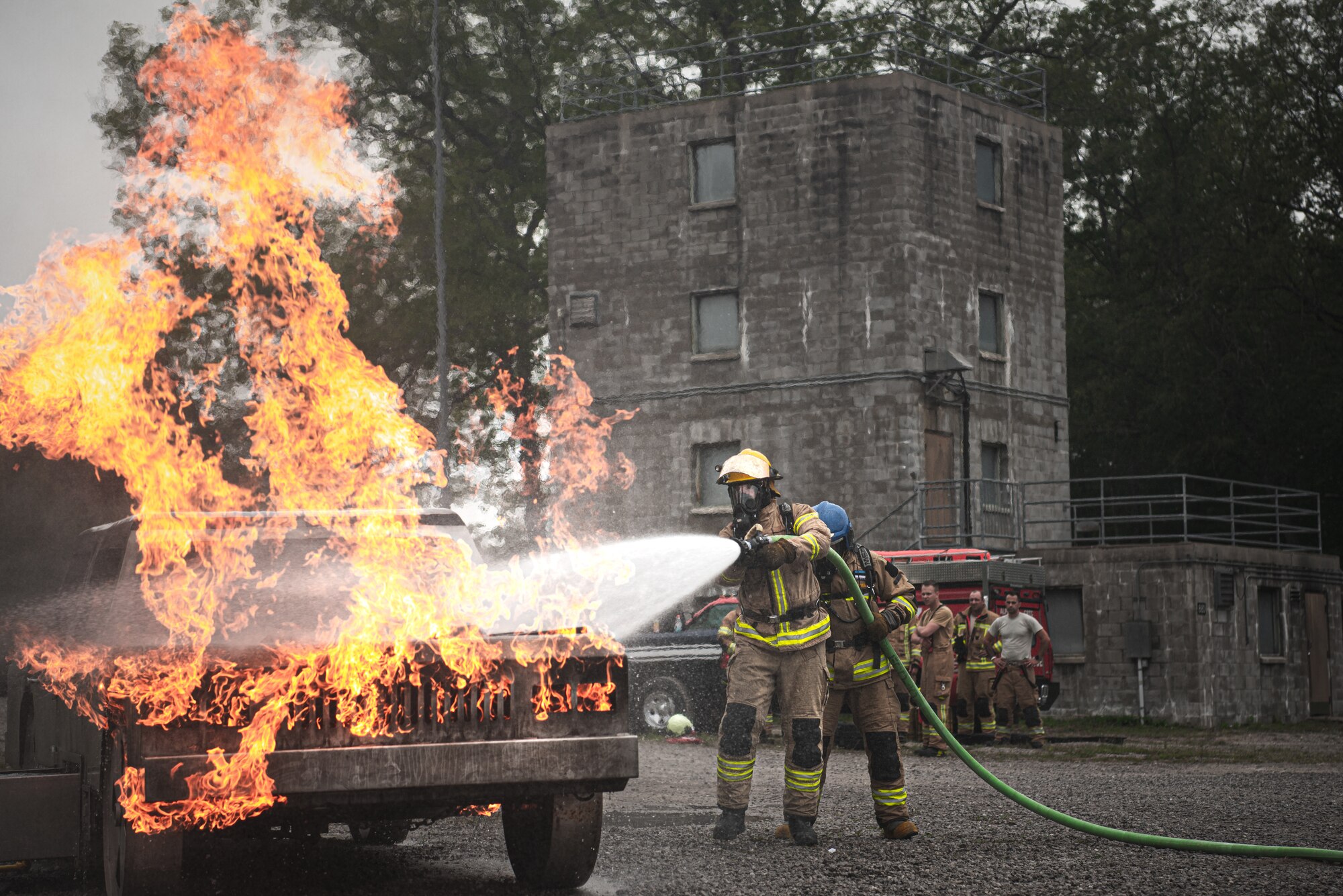 Latvian and Estonian firefighters train on a simulated car fire during Northern Strike 21-2 at the Alpena Combat Readiness Training Center, Michigan, on Aug. 6, 2021.