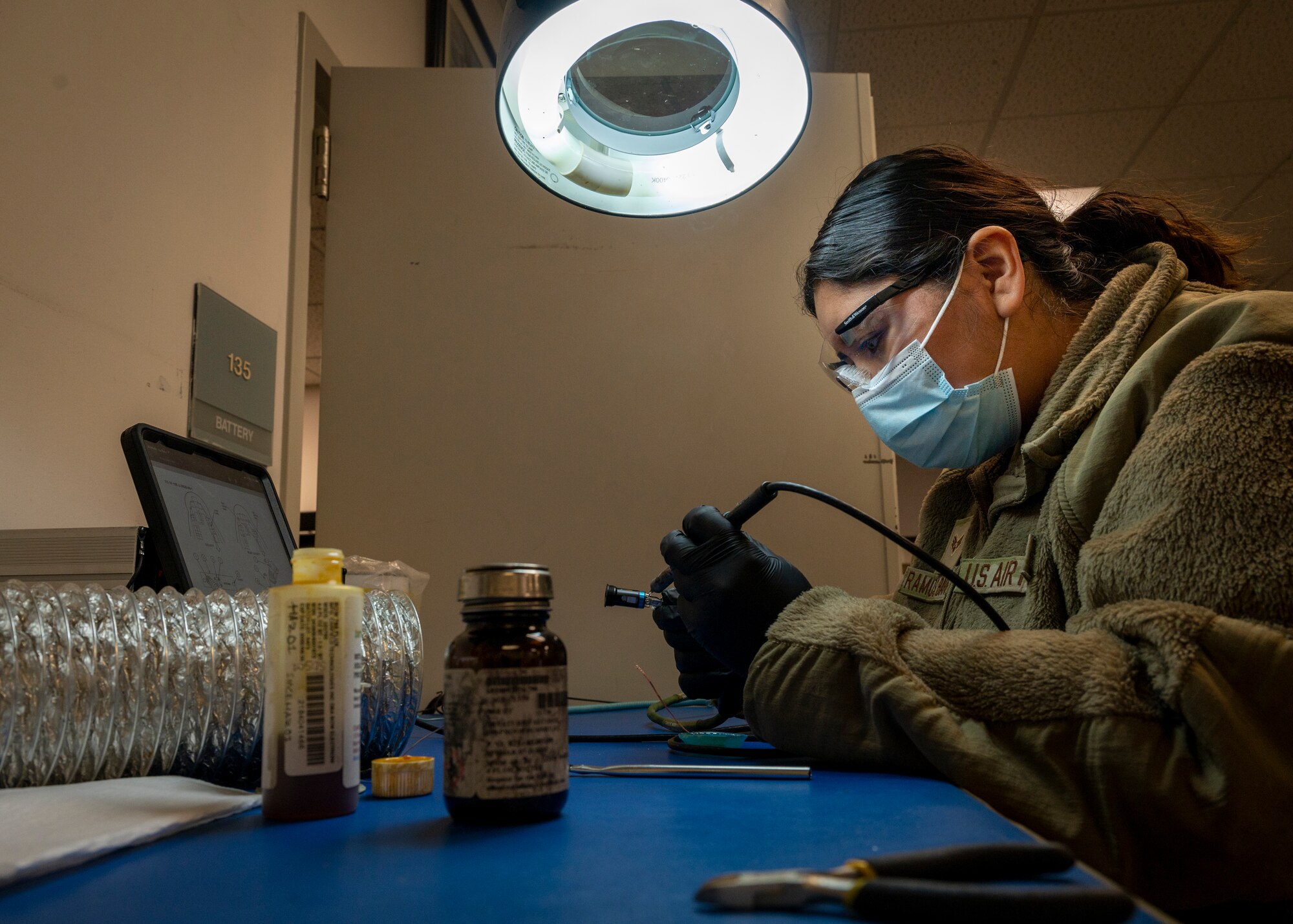 Senior Airman Jamie Ramos-Barrera, 4th Component Maintenance Squadron electrical environmental technician, works at the solder station to repair connections on an F-15E Strike Eagle communication cable at Seymour Johnson Air Force Base, North Carolina, Feb. 2, 2022.