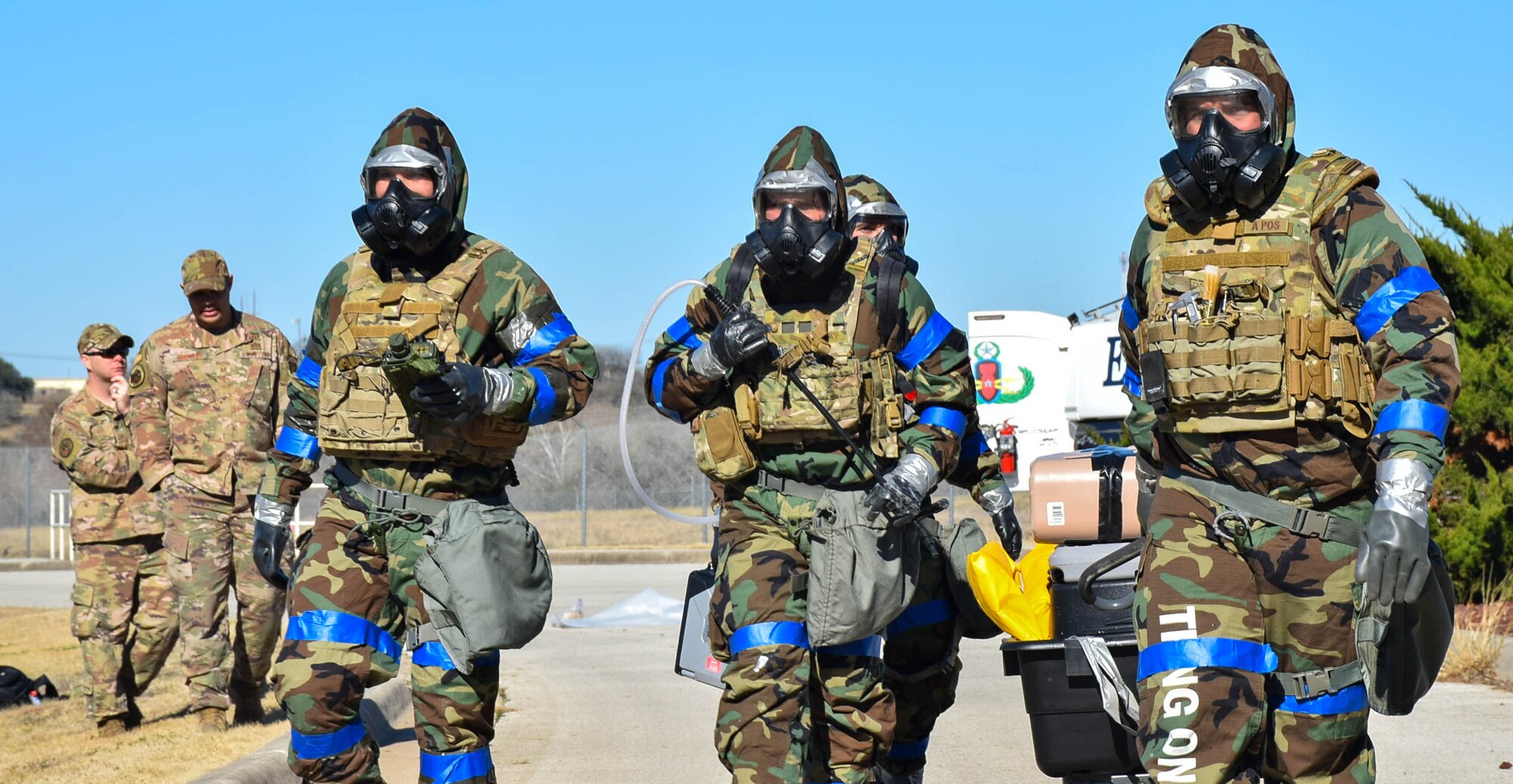 Explosive ordnance disposal technicians from the 433rd Civil Engineer Squadron walk towards a simulated unexploded ordnance site during an exercise at Joint Base San Antonio-Lackland, Texas, Feb. 9, 2022. (U.S. Air Force photo by Airman Mark Colmenares)
