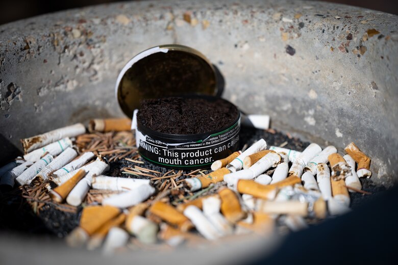 Chewing tobacco sits in a pile of cigarettes.