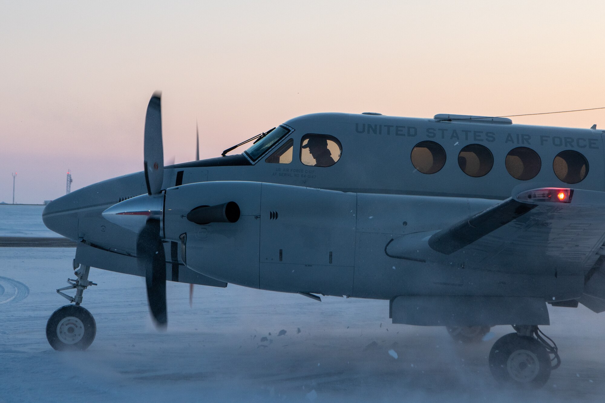 A U.S. Air Force C-12 Huron warms up before picking up the 611th Air Communications Squadron Mission Defense Team.