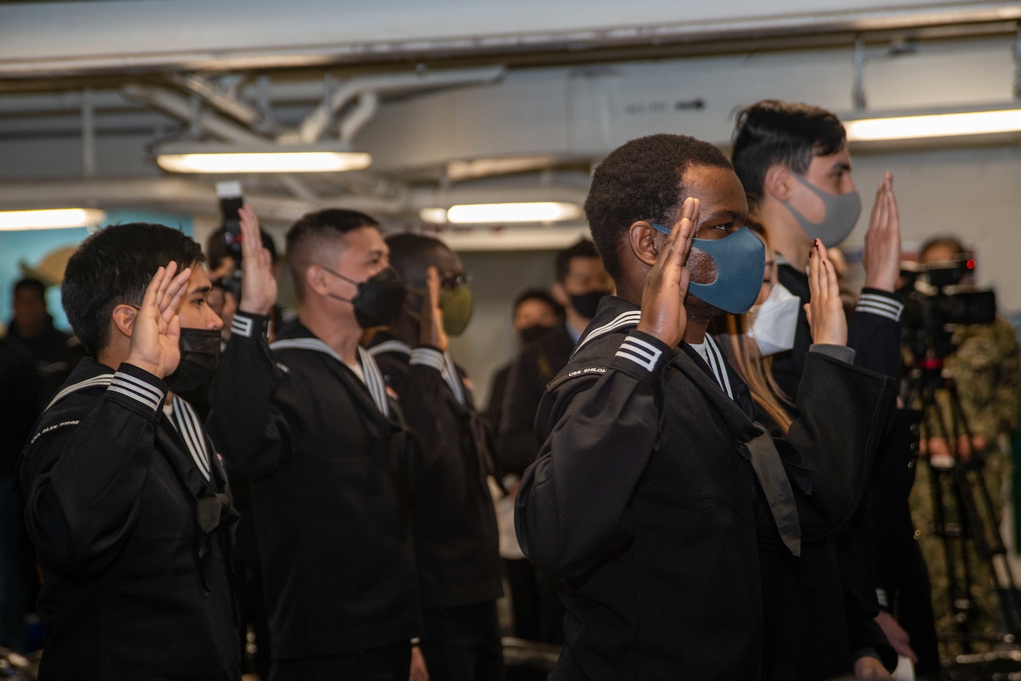 YOKOSUKA, Japan (Feb. 17, 2022) Candidates take the oath of citizenship during a naturalization ceremony in the forecastle of the U.S. Navy’s only forward-deployed aircraft carrier USS Ronald Reagan (CVN 76). During the ceremony, 17 candidates from 11 different countries became American citizens and the Honorable Rahm Emanuel, U.S. ambassador to Japan, served as the keynote speaker. Ronald Reagan, the flagship of Carrier Strike Group 5, provides a combat-ready force that protects and defends the United States, and supports alliances, partnerships and collective maritime interests in the Indo-Pacific region. (U.S. Navy photo by Mass Communication Specialist 3rd Class Gray Gibson)