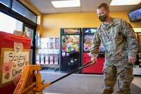 a soldier uses a pallet jack to move food