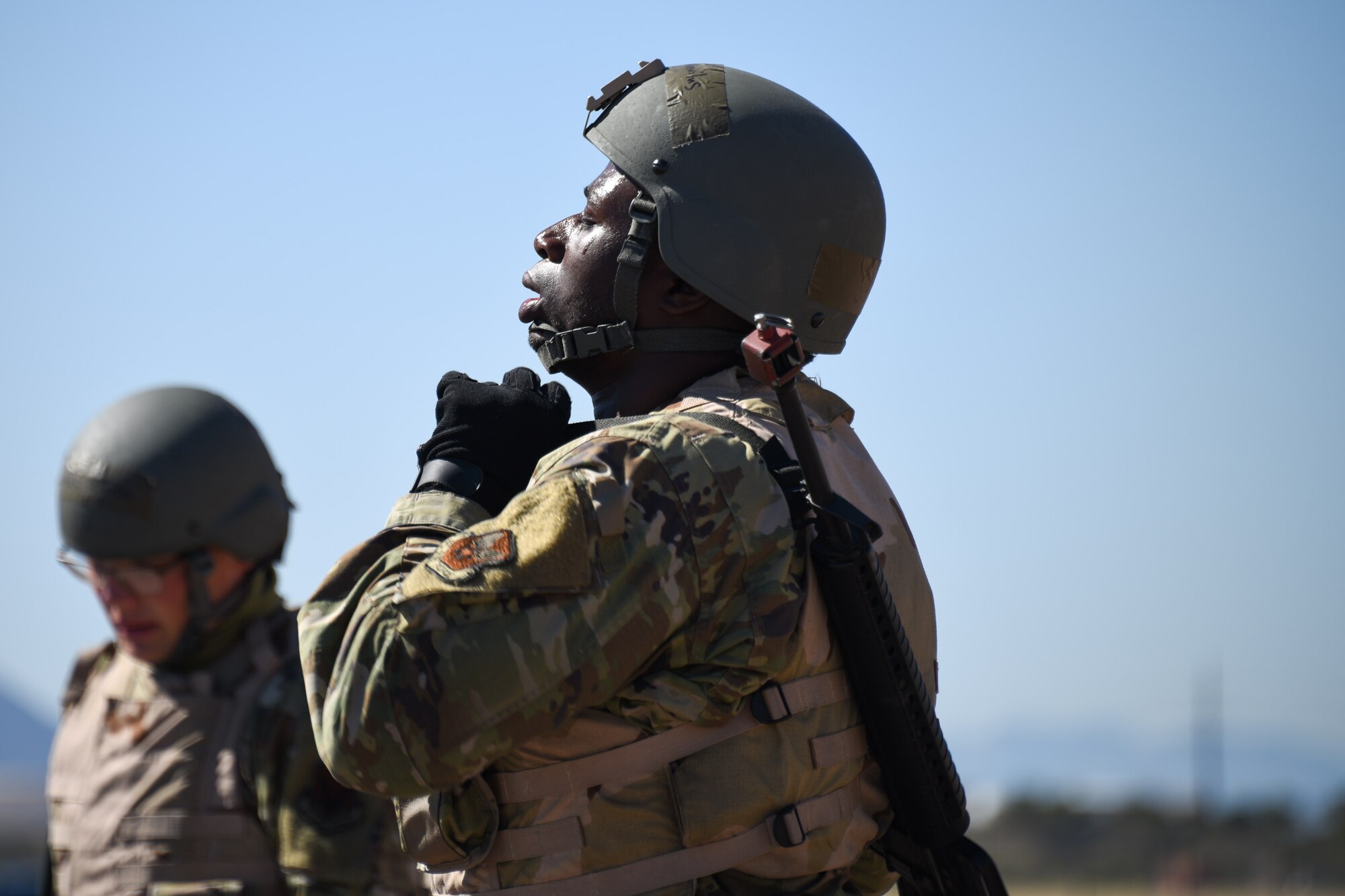 A photo of an Airman fastening his helmet.