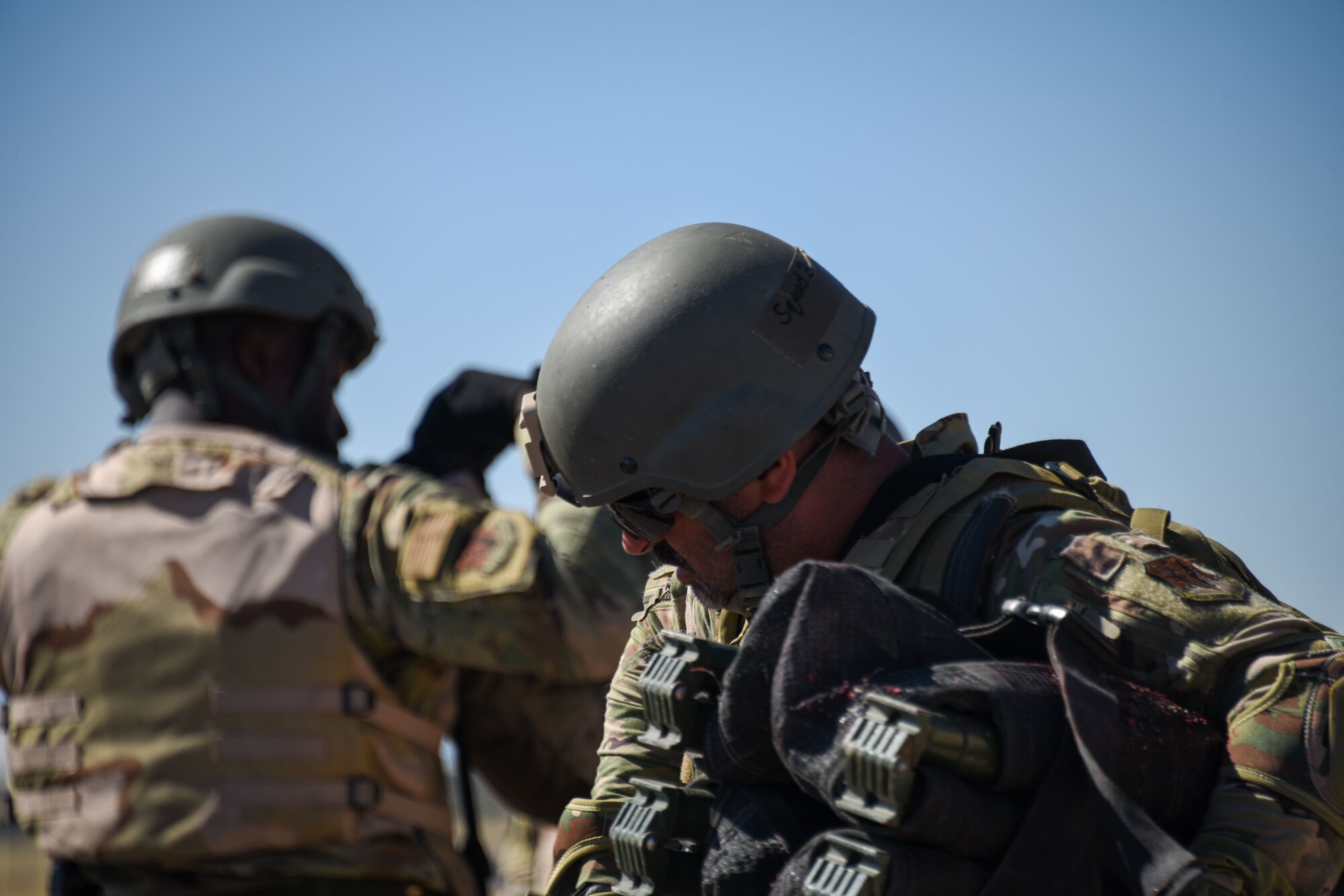 A photo of an Airman checking his gear.