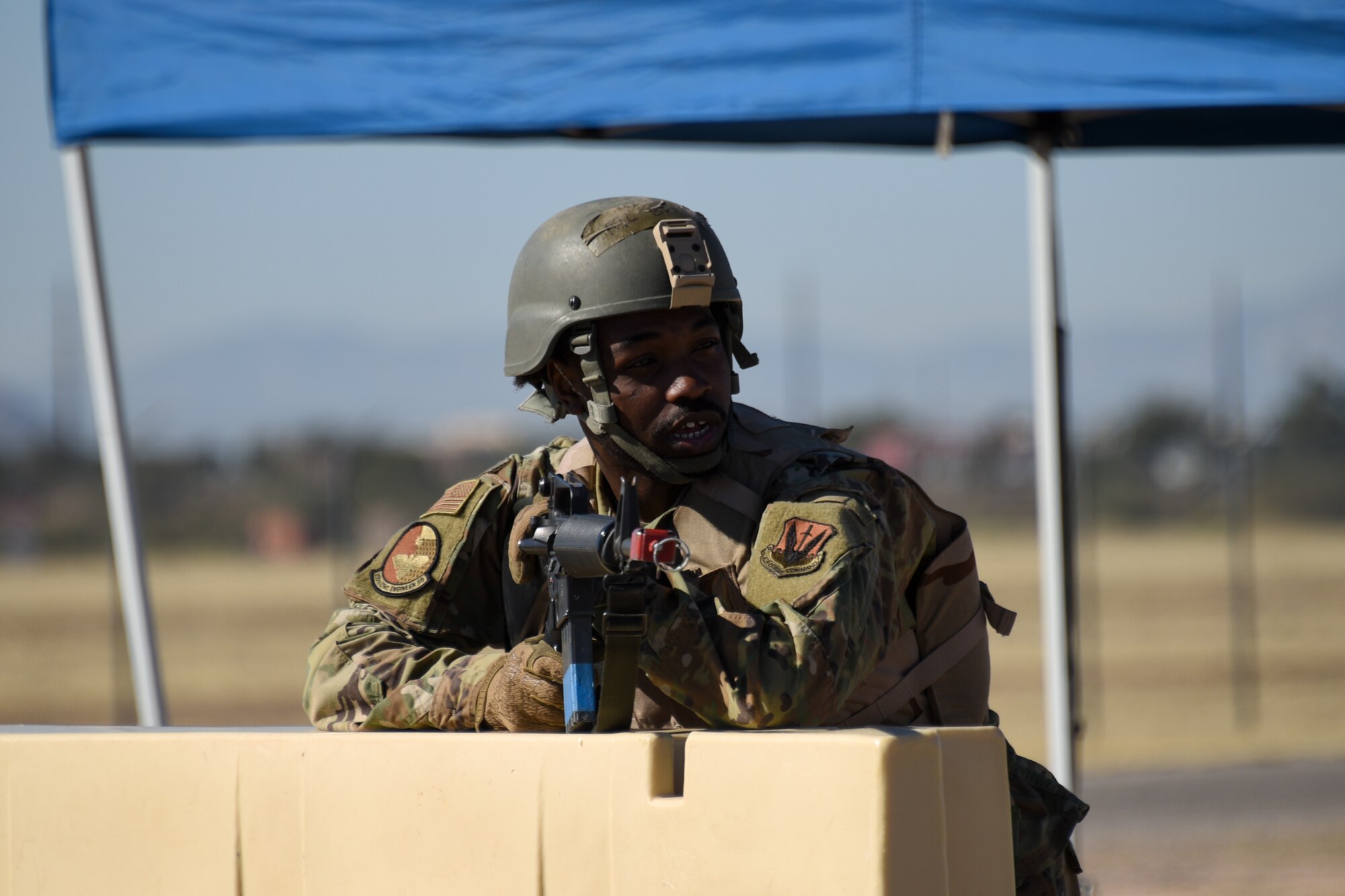 A photo of an Airman guarding an entry control point.