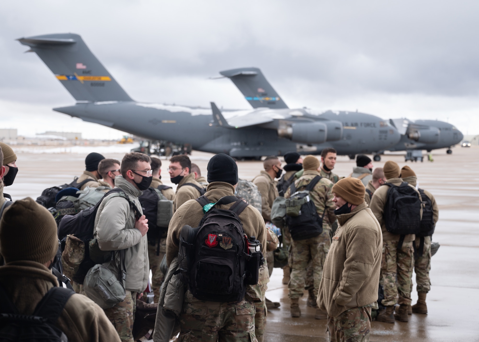 A photo of Airmen boarding a plane for deployment
