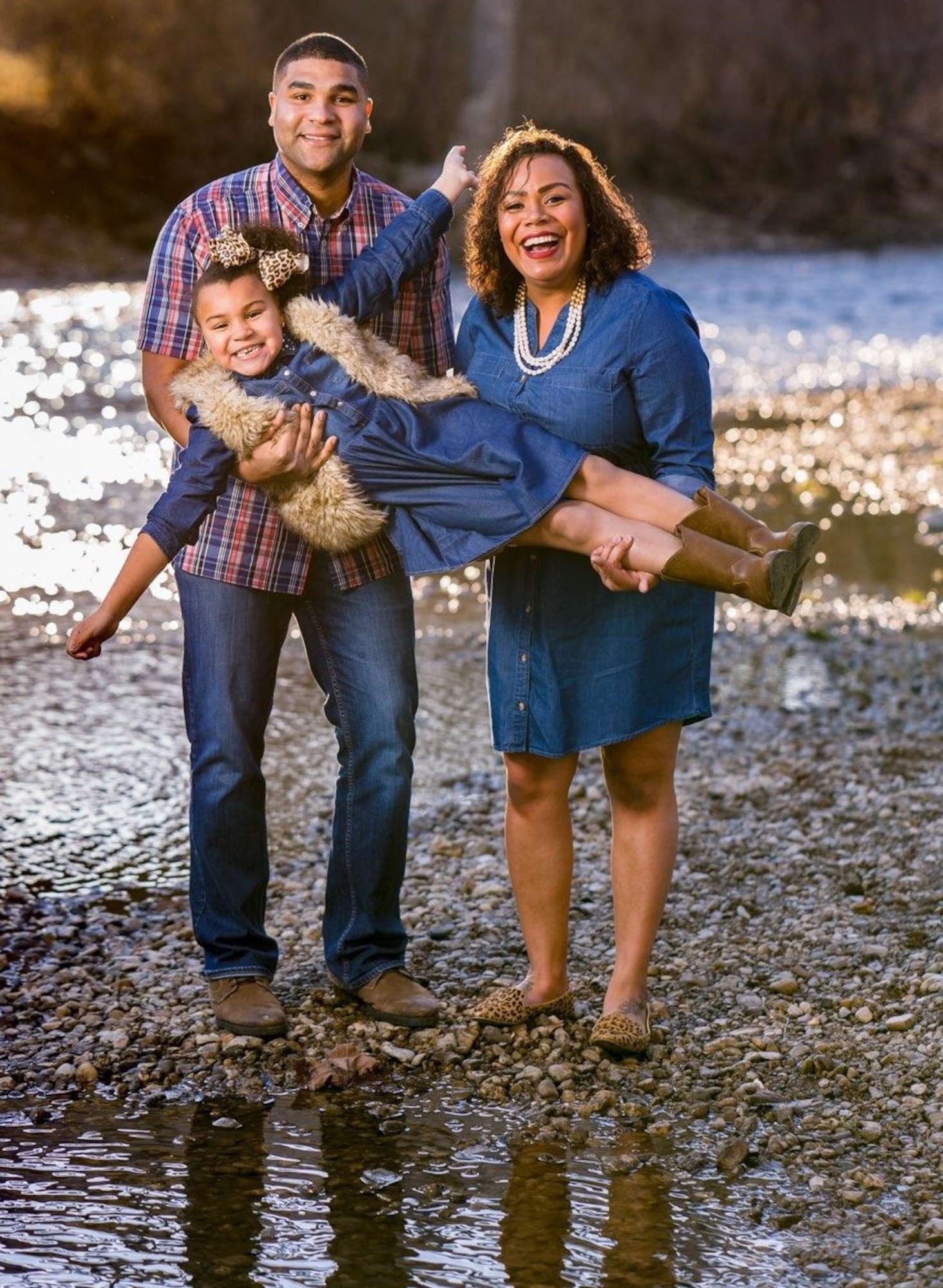 Master Sgt. Carlos Fernandez-Martinez, his wife Ashley and daughter Davyn as shown posing for the cover of their community's magazine. The family has purchased a home in Ohio and has built a positive support system with church, friends, and family.