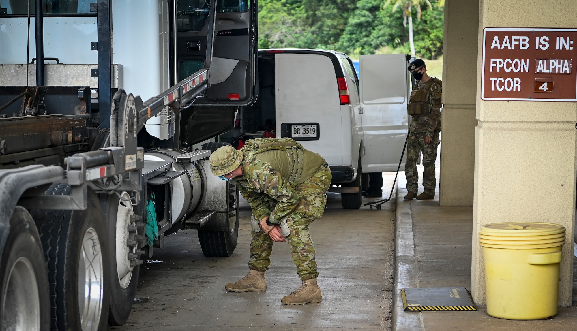 U.S. Air Force and Royal Australian Air Force personnel search vehicles at the vehicle inspection facility during Cope North 22 on Andersen Air Force Base, Guam, Feb. 15, 2022.
