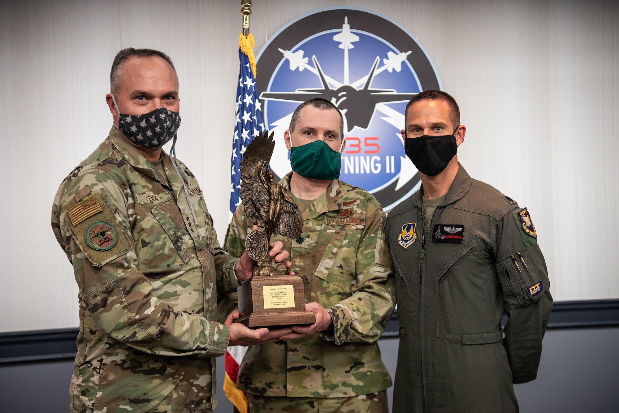 F-35 Joint Program Executive Officer (PEO), Lt. Gen. Eric Fick (far left), presents the prestigious Order of Daedalians Colonel Franklin C. Wolfe Weapons System Award for 2020 to F-35 Dual Capable Aircraft (DCA) Team Materiel Leader Lt. Col. Jason W. Shirley (center) and Commander, 461st Flight Test Squadron/Director, F-35 Integrated Test Force Lt. Col. Christopher “SIN” Campbell (far right). In 2020, the then 26-person F-35 DCA Team completed a vital development test campaign a full year ahead of schedule, which earned them this award. The award is presented annually to military or civilian individuals, groups or an organization determined to have contributed the most outstanding weapons system development which operates, in whole or in part, in the aerospace environment. The F-35 Joint Program Office is the Department of Defense's focal point for the 5th generation strike aircraft for the U.S. Navy, Air Force, and Marine Corps, as well as for our International Partners and Foreign Military Sales Customers. The F-35 is the premier multi-mission, 5th generation weapon system. Its ability to collect, analyze and share data is a force multiplier that enhances all assets in the battle-space: with stealth technology, advanced sensors, weapons capacity, and range. The F-35, which has been operational since July of 2015, is the most survivable, and interoperable fighter aircraft ever built. (Photo by America Henry-Wingo)