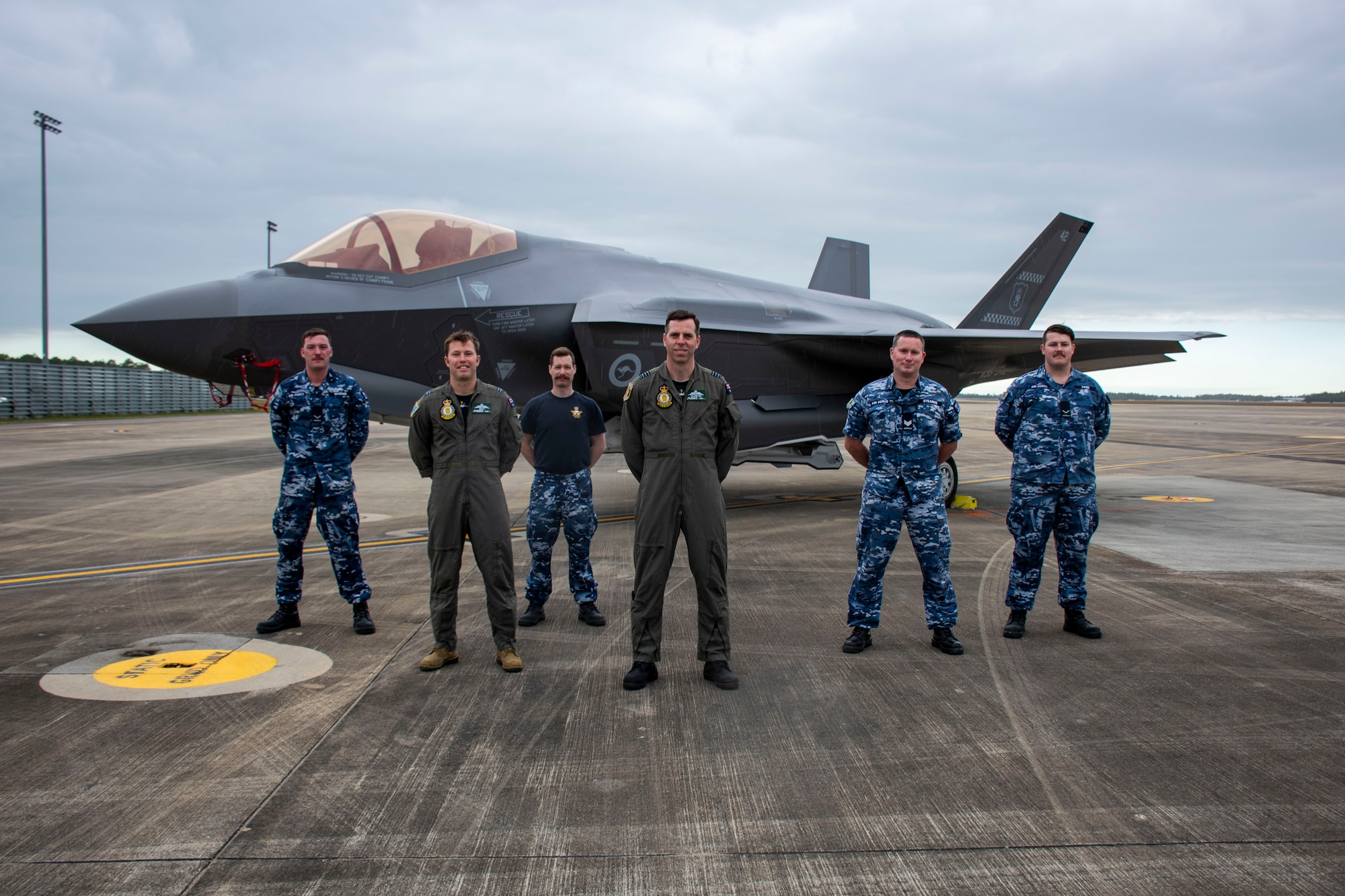 Wing Commander Tim Ireland, Commanding Officer of No 77 Squadron and F-35A pilot, stands alongside members of the Royal Australian Air Force in front of an F-35A Lightning II on Nov. 23, 2021, at Eglin Air Force Base, Fla. This is the second year No 77 Squadron has participated in Exercise Lightning Spear, a live-fire missile event supported by the 53rd Wing, that evaluates the entire unit on their ability to support the AIM-120D Advanced Medium Range Air-to-Air Missile combat capability of their F-35s. (U.S. Air Force photo by 1st Lt. Lindsey Heflin)