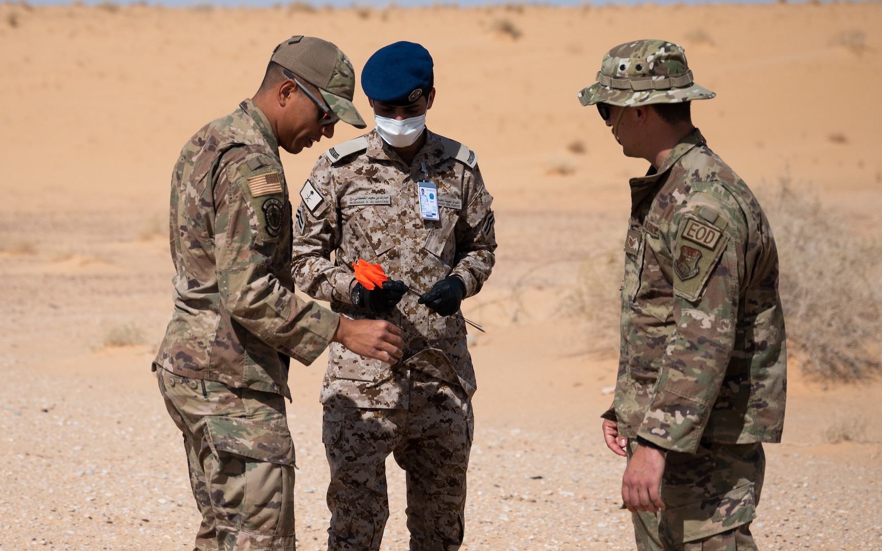 Service members from the Royal Saudi Air Force and the U.S. Air Force inspect a simulated piece of evidence during a bilateral training exercise at Prince Sultan Air Base, Kingdom of Saudi Arabia, Feb. 10, 2022. U.S. Air Force units designed to respond to real world explosive incidents led the training by incorporating their RSAF counterparts in their processes. (U.S. Air Force photo by Senior Airman Jacob B. Wrightsman)