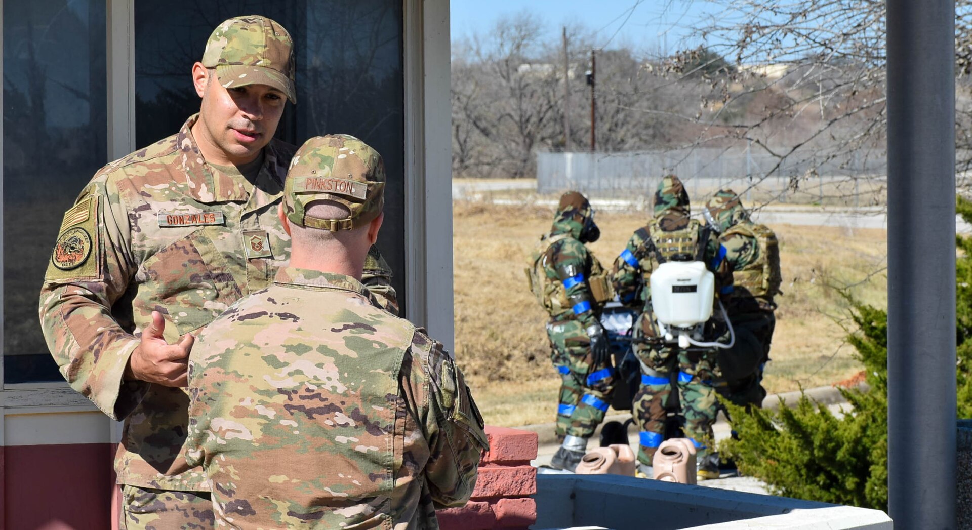 Master Sgt. James Gonzales, 433rd Civil Engineer Squadron explosive ordnance disposal training section supervisor, talks with Master Sgt. Robert Pinkston, 433rd CES EOD program manager, during an exercise at Joint Base San Antonio-Lackland, Texas, Feb. 9, 2022. Both Gonzales and Pinkston evaluated EOD technicians during their training tasks. (U.S. Air Force photo by Airman Mark Colmenares)