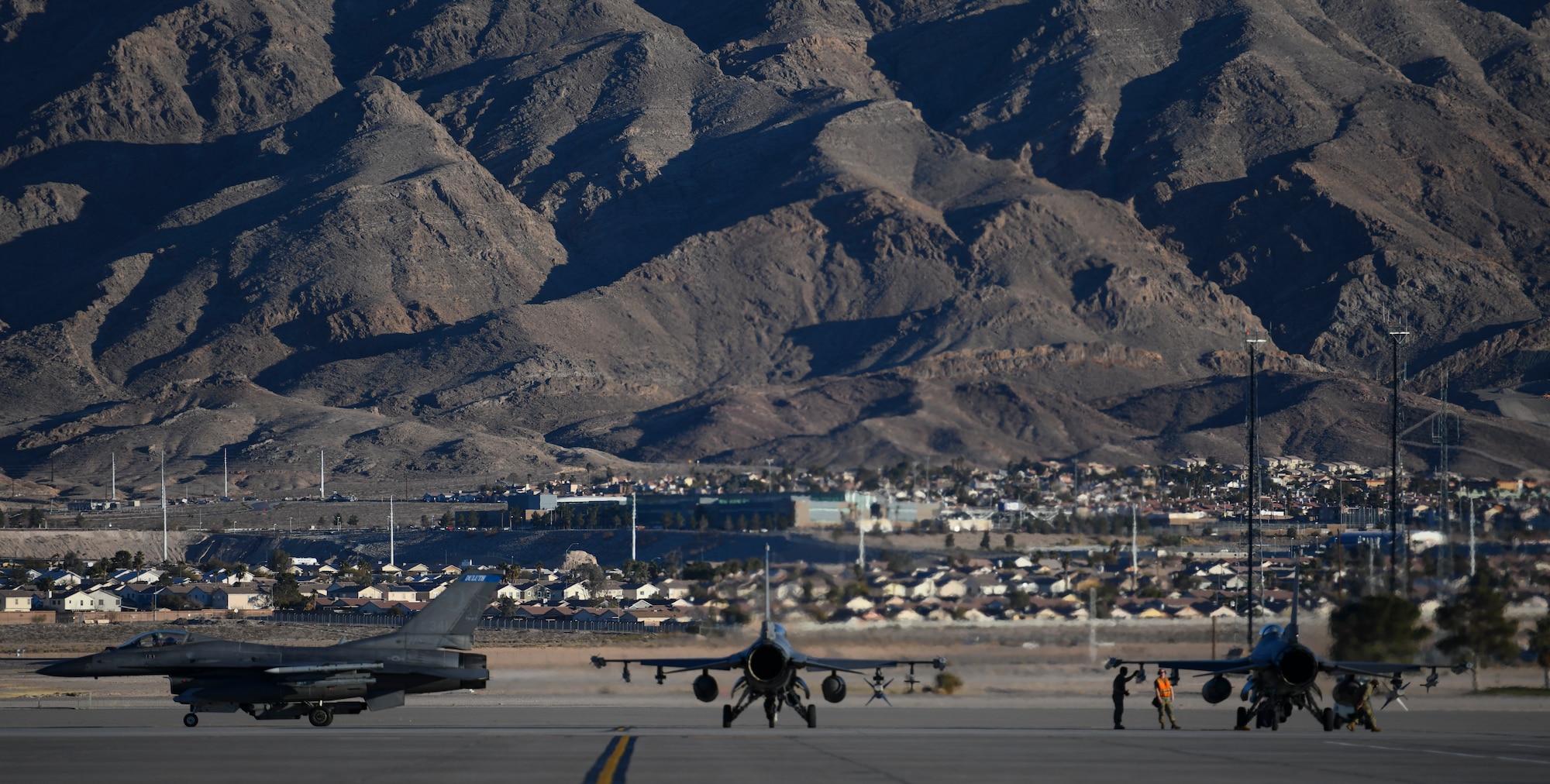 U.S. Air Force F-16 Crew Chiefs assigned to the 148th Fighter Wing, Minnesota Air National Guard, Duluth, Minn., perform routine checks at the end of runway prior to launching Block 50 F-16CM Fighting Falcons at Nellis Air Force Base, Nev., Feb 8, 2022, while participating in Red Flag 22-1.