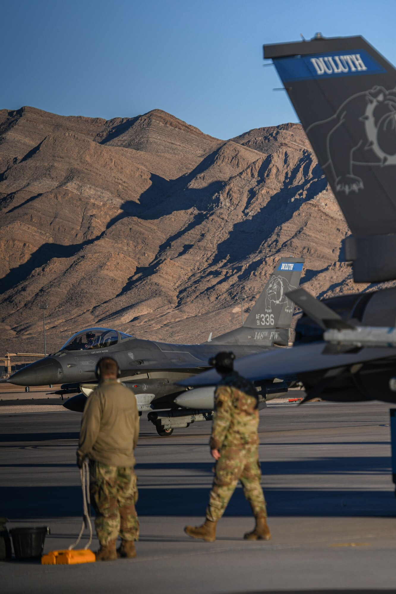 U.S. Air Force F-16 Crew Chiefs assigned to the 148th Fighter Wing, Minnesota Air National Guard, Duluth, Minn., await the arrival of a Block 50 F-16CM Fighting Falcon at Nellis Air Force Base, Nev., Feb 8, 2022, while participating in Red Flag-Nellis 22-1.