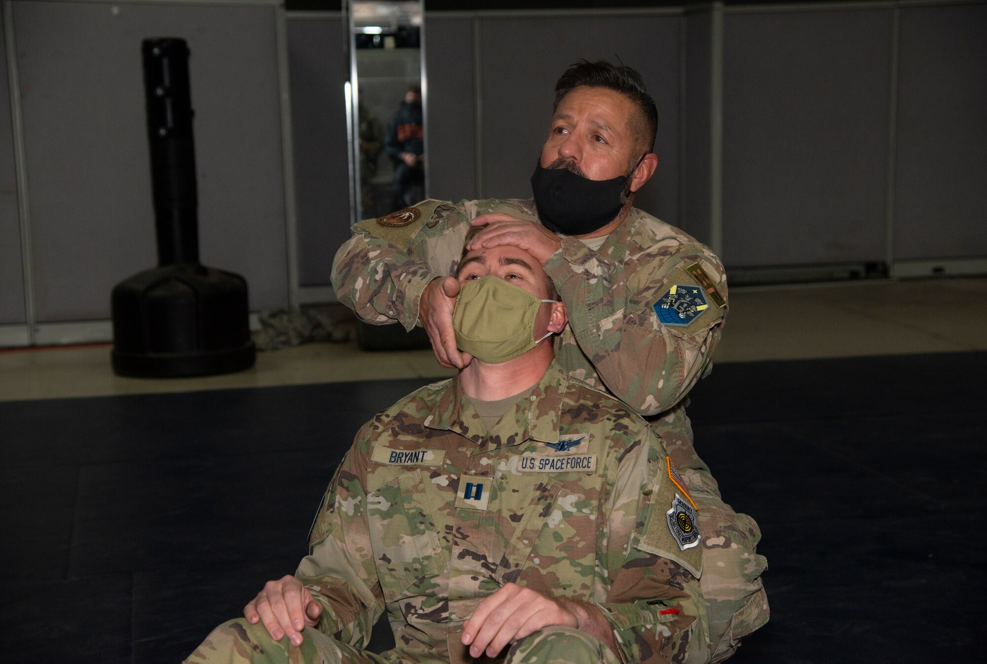 Isaac Lopez, 21st Security Forces Squadron unit trainer, demonstrates a pressure point control technique on U.S. Space Force Capt. Jeffrey “Frog” Bryant, Space Delta 3 - Space Electromagnetic Warfare, 4th Space Control Squadron officer in charge of tactics development.