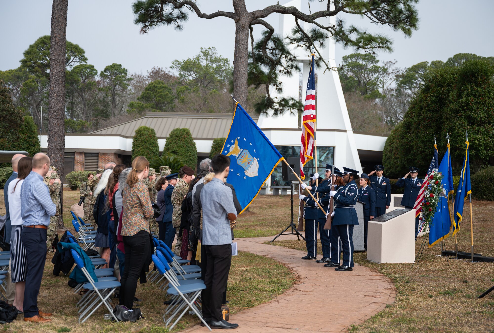 Family members of fallen Air Commandos stand for the National Anthem during a memorial ceremony at Hurlburt Field, Florida, Feb. 17, 2022.