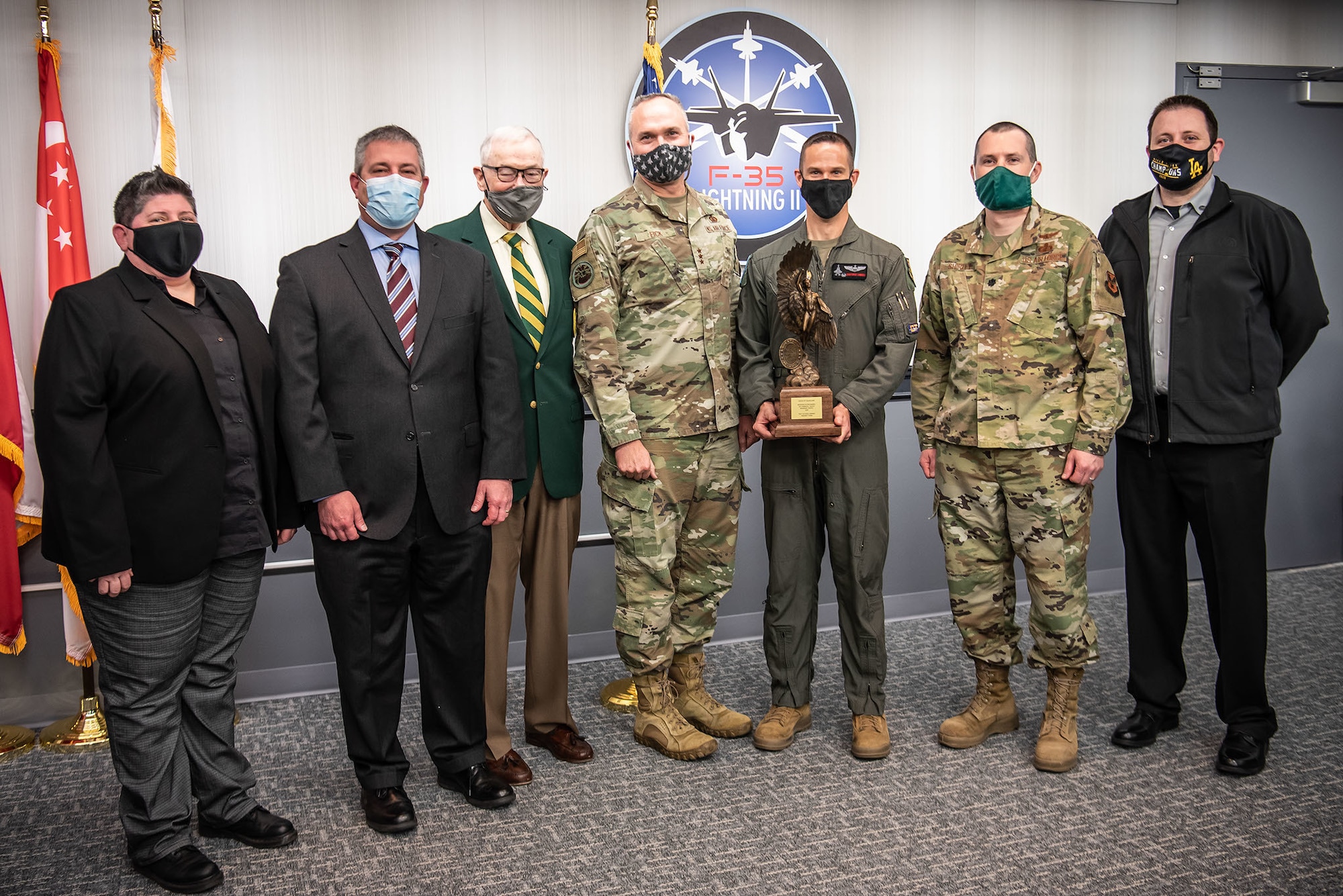 CRYSTAL CITY, VA. (Feb. 16, 2022) – Members of the F-35 Dual Capable Aircraft Team are recognized for outstanding weapons system development during a small awards ceremony at the F-35 Joint Program Office headquarters in Arlington, Virginia. Chief of Staff of the Air Force Gen. Charles “CQ” Brown chose the 26-person F-35 DCA Team as the recipient of the prestigious Order of Daedalians Colonel Franklin C. Wolfe Weapons System Award for 2020 in recognition of the team’s efforts that year to complete a vital developmental test campaign a full year ahead of original schedule. This test campaign is a critical step toward nuclear certification of the Air Force’s F-35 A variant. F-35 Program Executive Officer Lt. Gen. Eric Fick (center) and Past Commander of the Order of the Daedalians, Lt. Gen. (Ret.) Nicholas B. Kehoe (third from left) presented the award to five representatives of the team: (left to right) former F-35 Capability Verification Mission Systems test lead Cassandra “Cassie” Allen; F-35 Deputy Program Manager for Nuclear Matters Charles E. (Chad) Lominac II; Commander, 461st Flight Test Squadron/Director, F-35 Integrated Test Force Lt. Col. Christopher “SIN” Campbell; F-35 Dual Capable Aircraft (DCA) Team Materiel Leader Lt. Col. Jason W. Shirley; and Lead Engineer, Weapons Integration Dustin L. Malcolm. The award is presented annually to military or civilian individuals, groups or an organization determined to have contributed the most outstanding weapons system development which operates, in whole or in part, in the aerospace environment. The F-35 Joint Program Office is the Department of Defense's focal point for the 5th generation strike aircraft for the U.S. Navy, Air Force, and Marine Corps, as well as for our International Partners and Foreign Military Sales Customers. The F-35 is the premier multi-mission, 5th generation weapon system. Its ability to collect, analyze and share data is a force multiplier that enhances all assets in th