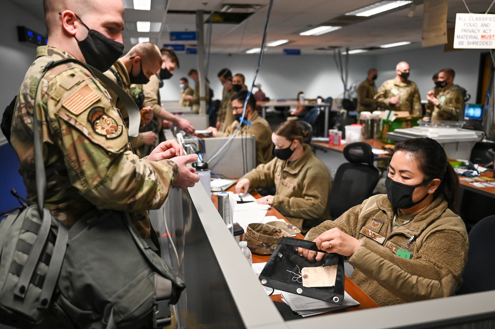 Staff Sgt. Aizhan Goode and Staff Sgt. Taylor Saunders (right), 75th Force Support Squadron, process Airmen through a pre-deployment mobility line Feb. 16, 2022, at Hill Air Force Base, Utah. Airmen from the active duty 388th and Reserve 419th Fighter Wings were deployed with F-35A Lightning II aircraft to Spangdahlem Air Base, Germany, to bolster readiness and enhance NATO’s collective defensive posture. (U.S. Air Force photo by Cynthia Griggs)