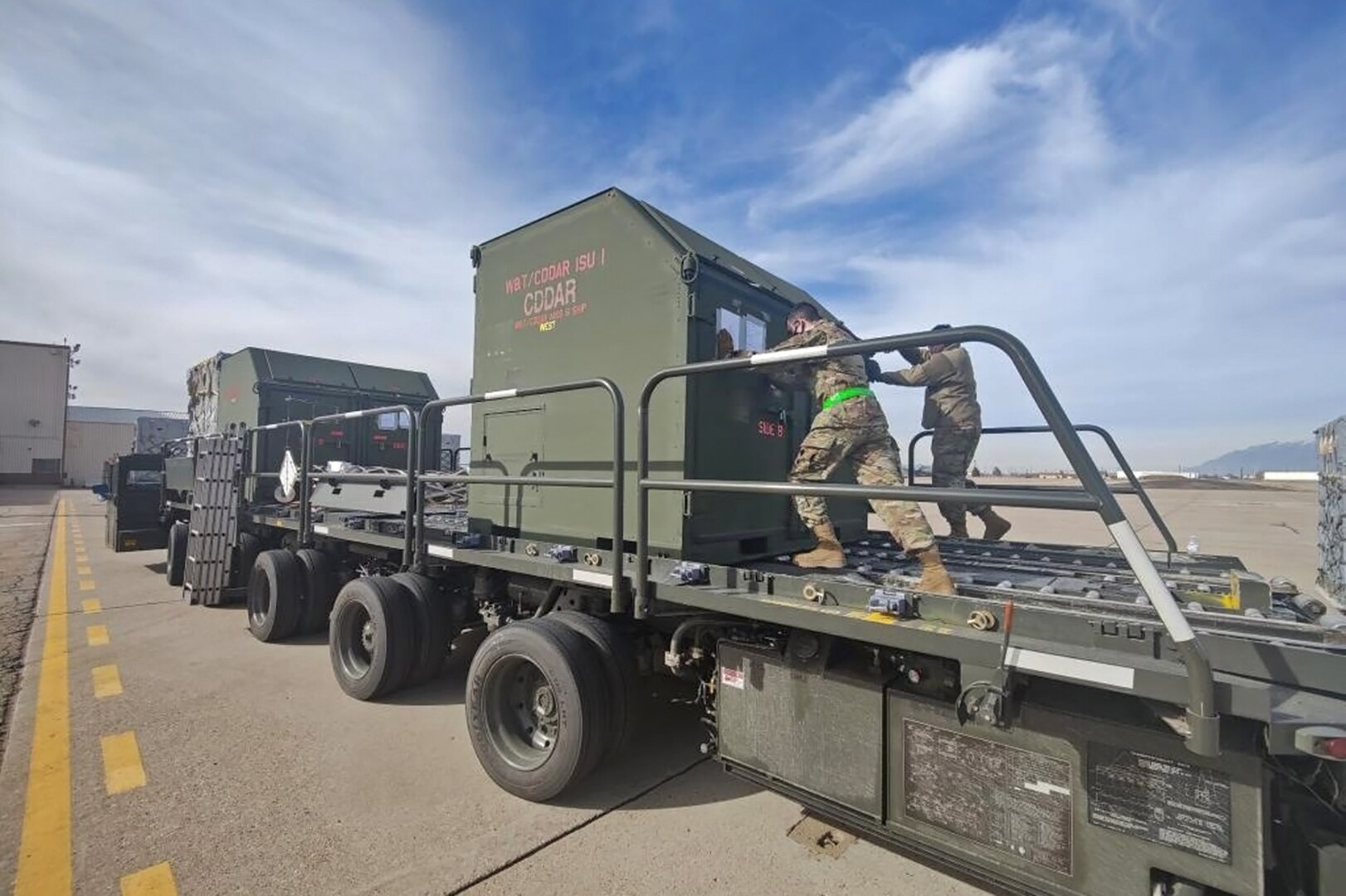 Airmen from 75th Logistics Readiness Squadron transport cargo containers filled with F-35A Lightning II mission and support equipment before being loaded on an Air Force C-17 Globemaster Feb. 14, 2022, at Hill Air Force Base, Utah. The Airmen were supporting the deployment of the active duty 388th and Reserve 419th Fighter Wings to Spangdahlem Air Base, Germany to bolster readiness and enhance NATO's collective defensive posture. (U.S. Air Force photo by Micah Garbarino)