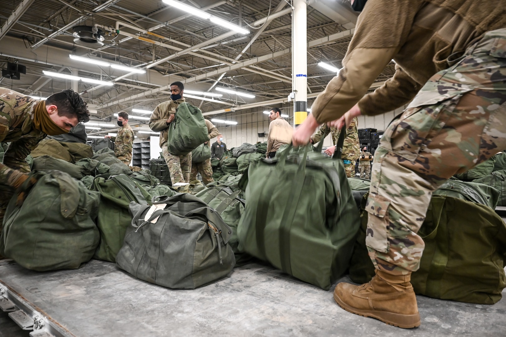 Airmen from 75th Logistics Readiness Squadron and 388th Fighter Wing load mobility bags onto pallets Feb. 17, 2022, at Hill Air Force Base, Utah. Airmen from the active duty 388th and Reserve 419th Fighter Wings were deployed with F-35A Lightning II aircraft to Spangdahlem Air Base, Germany, to bolster readiness and enhance NATO’s collective defensive posture. (U.S. Air Force photo by Cynthia Griggs)