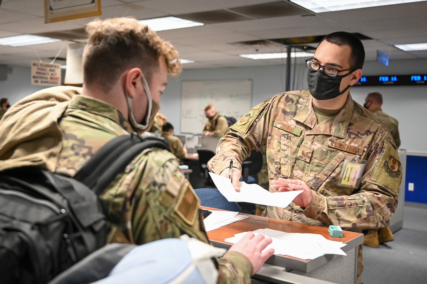 Tech. Sgt. Marc Dennis (right), 75th Medical Group, processes an Airman through a pre-deployment mobility line Feb. 16, 2022, at Hill Air Force Base, Utah. Airmen from the active duty 388th and Reserve 419th Fighter Wings were deployed with F-35A Lightning II aircraft to Spangdahlem Air Base, Germany, to bolster readiness and enhance NATO’s collective defensive posture. (U.S. Air Force photo by Cynthia Griggs)