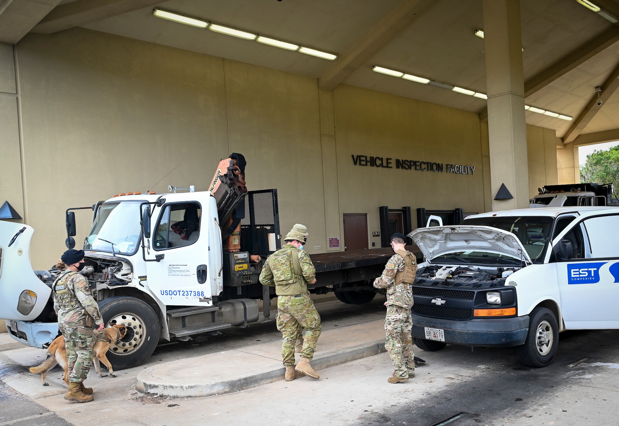 U.S. Air Force and Royal Australian Air Force personnel search vehicles at the vehicle inspection facility during Cope North 22 on Andersen Air Force Base, Guam, Feb. 15, 2022.