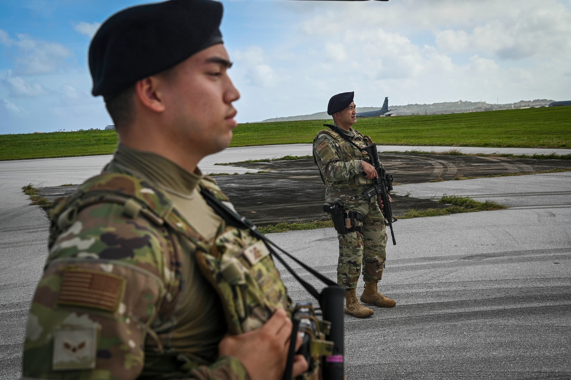 U.S. Air Force Airman 1st Class Brayven Chase (left) and USAF Tech. Sgt. Jude Camemo, assigned to the 254th Security Forces Squadron, provide flight line security during exercise Cope North 22 on Andersen Air Base, Guam, Feb. 14, 2022.