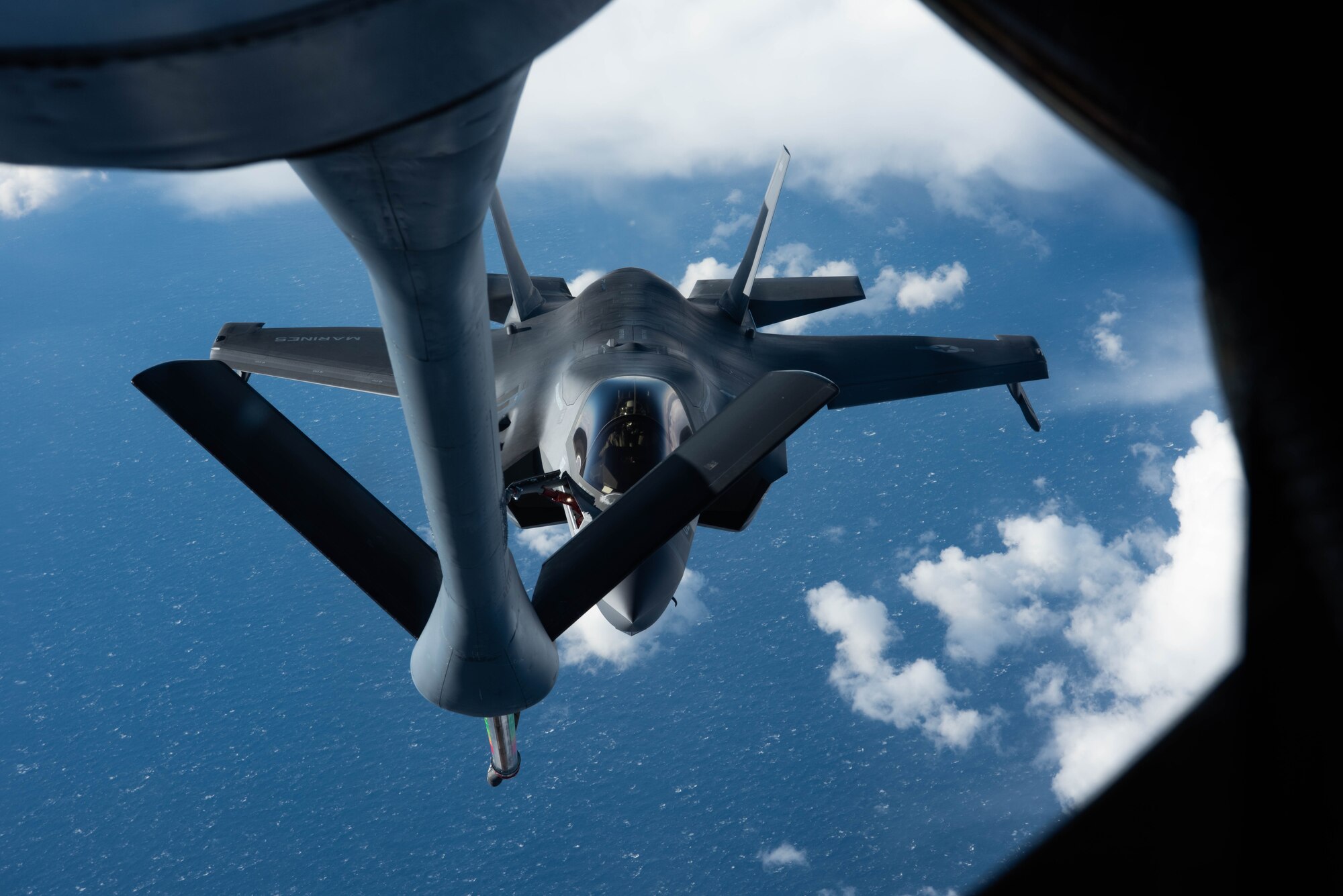 A jet approaches an aircraft for refueling.