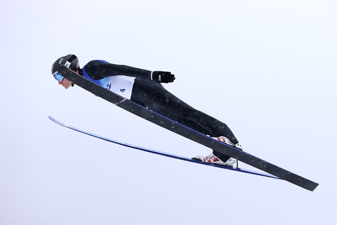 A skier moves through the air on a slope.