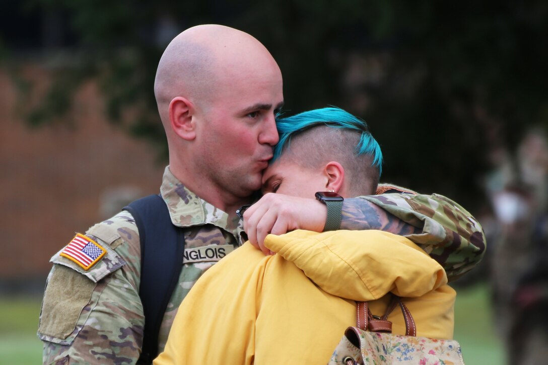 A soldier embraces a loved one.