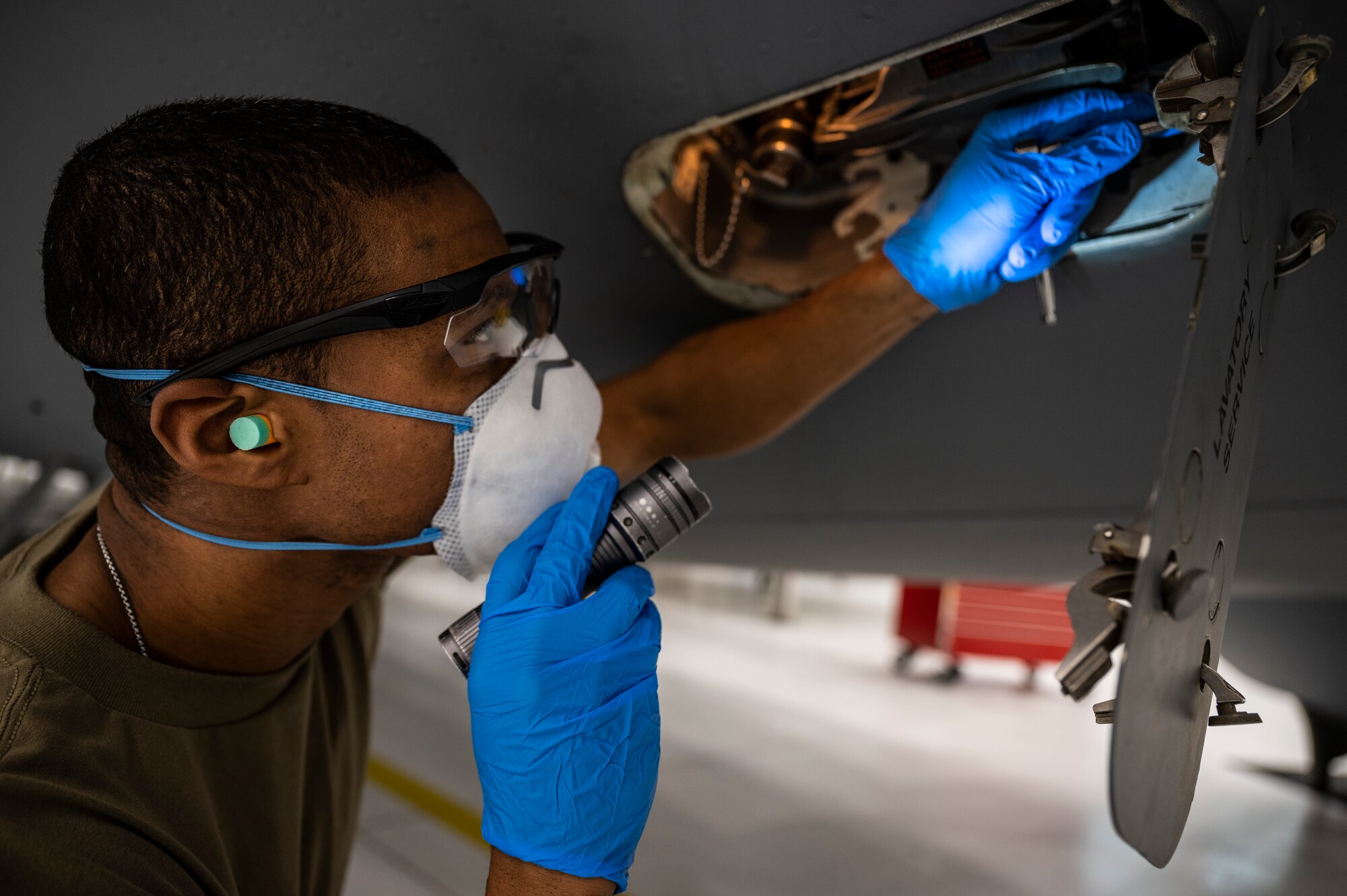 Tech. Sgt. Larry Price, 911th Maintenance Squadron crew chief, tightens a bolt in the lavatory service compartment during a home station check inspection of a C-17 Globemaster III at the Pittsburgh International Airport Air Reserve Station, Pennsylvania, Feb. 8, 2022.