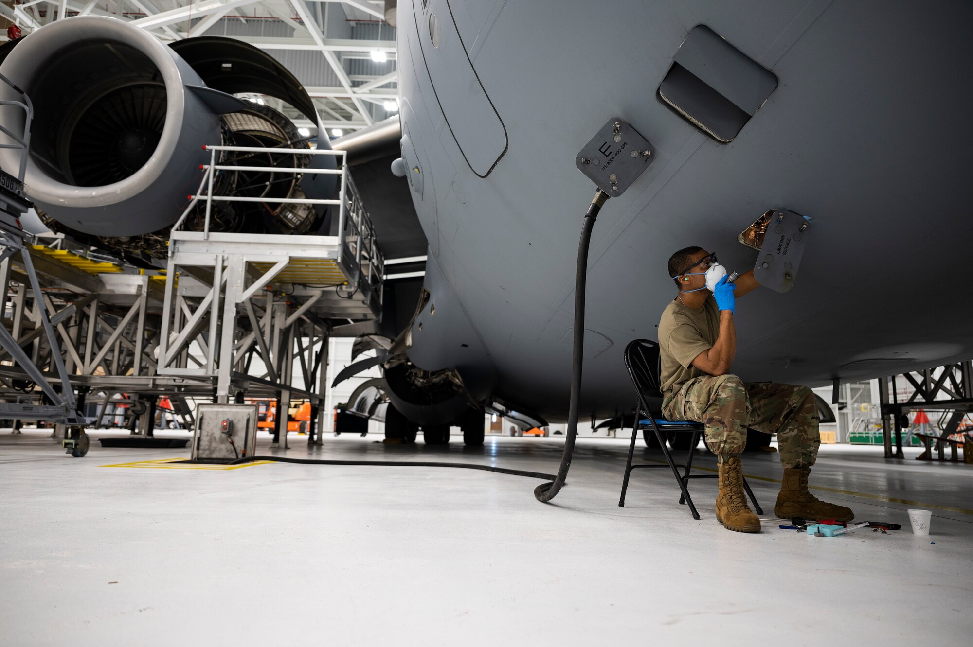 Tech. Sgt. Larry Price, 911th Maintenance Squadron crew chief, tightens a bolt in the lavatory service compartment during a home station check inspection of a C-17 Globemaster III at the Pittsburgh International Airport Air Reserve Station, Pennsylvania, Feb. 8, 2022.