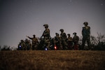 Oklahoma National Guard Mission Sustainment Team students use binocular night vision goggles during a field exercise in Oklahoma City Feb. 10, 2022. The students used the night vision devices to learn how to observe their surroundings and conceal their movement in the dark.