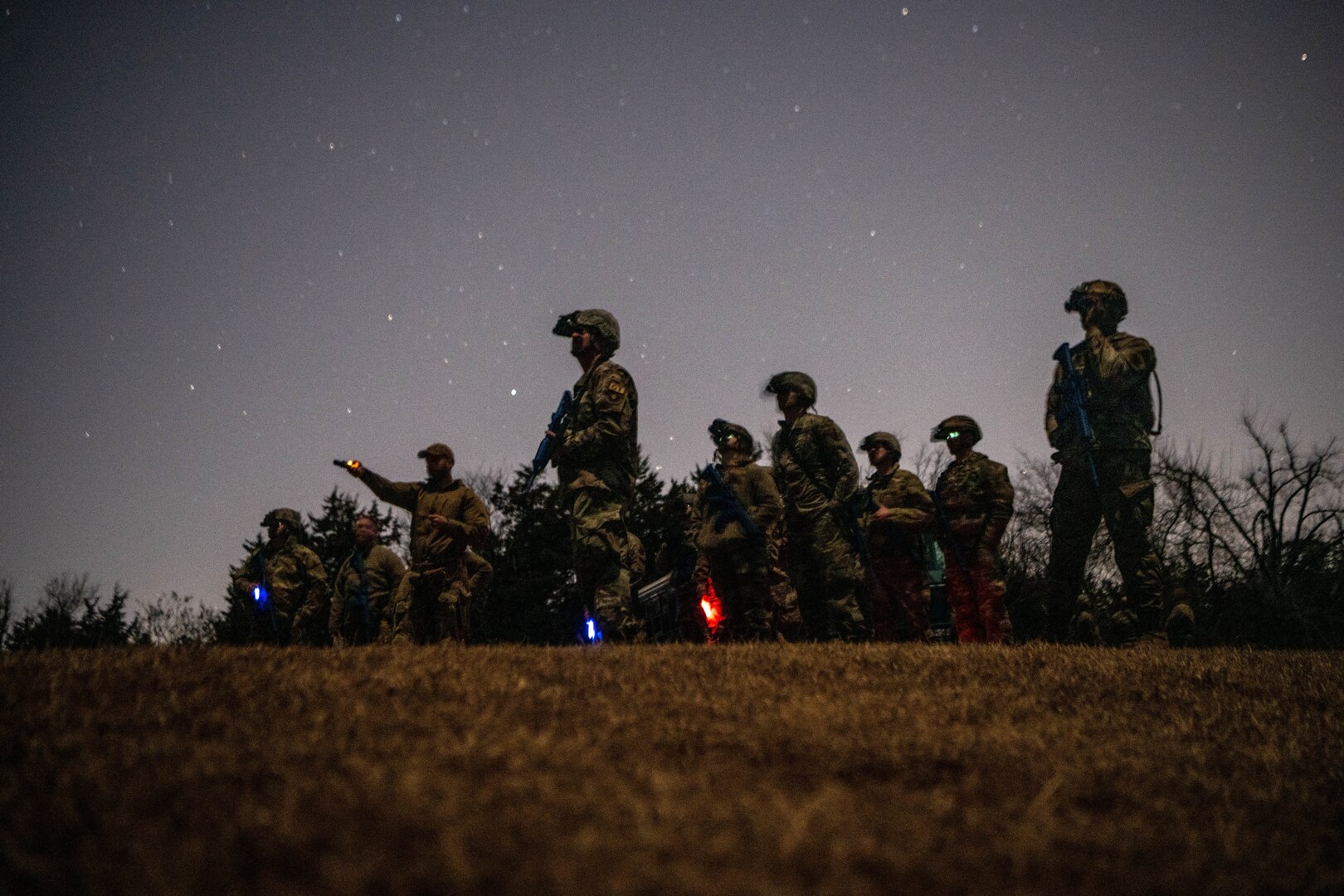 Oklahoma National Guard Mission Sustainment Team students use binocular night vision goggles during a field exercise in Oklahoma City Feb. 10, 2022. The students used the night vision devices to learn how to observe their surroundings and conceal their movement in the dark.