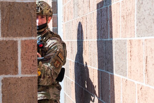 An 88th Security Forces Squadron Airman secures a building perimeter during an active-shooter exercise Aug. 18 at Wright-Patterson Air Force Base. First responders are essential to protecting the base, but all personnel must follow specific guidance to stay safe in emergency situations. (U.S. Air Force photo by Wesley Farnsworth)