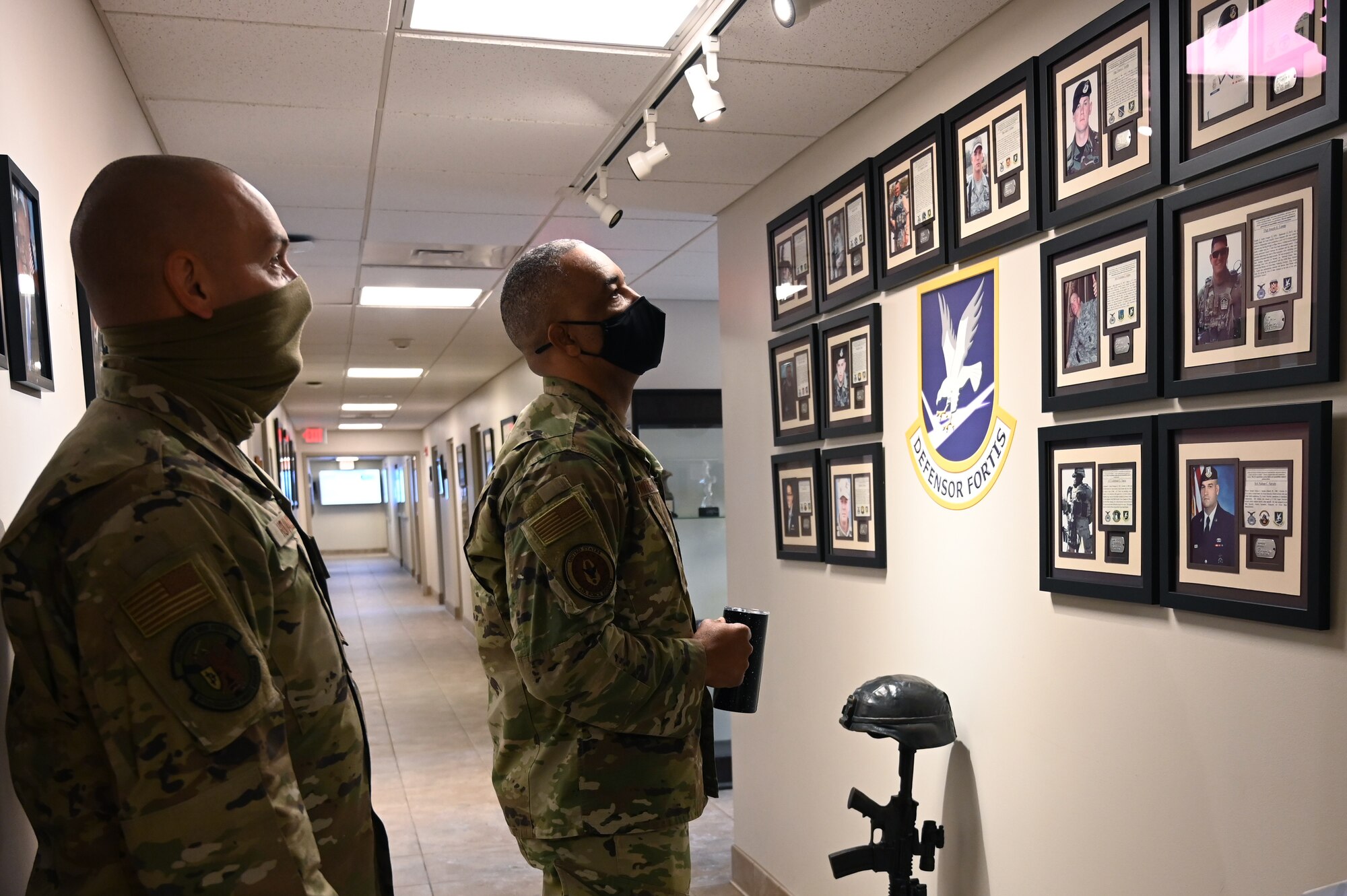 Chief Master Sgt. Timothy C. White, the Air Force Reserve Command Chief, observes the wall of fallen Airmen in the 911th Security Forces Squadron with Chief Master Sgt. Justin Hovancik, 911th SFS operations superintendent, at the Pittsburgh International Airport Air Reserve Station, Pennsylvania, Jan. 8, 2022.