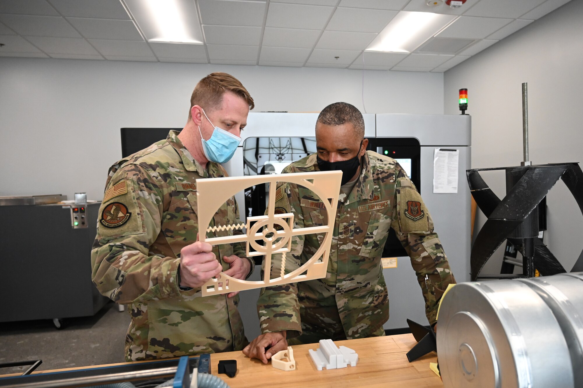 Chief Master Sgt. Timothy C. White, the Air Force Reserve Command Chief, speaks with Master Sgt. Michael J. Howard, 911th Maintenance Squadron sheet metal technician, at the Pittsburgh International Airport Air Reserve Station, Pennsylvania, Jan. 8, 2022.