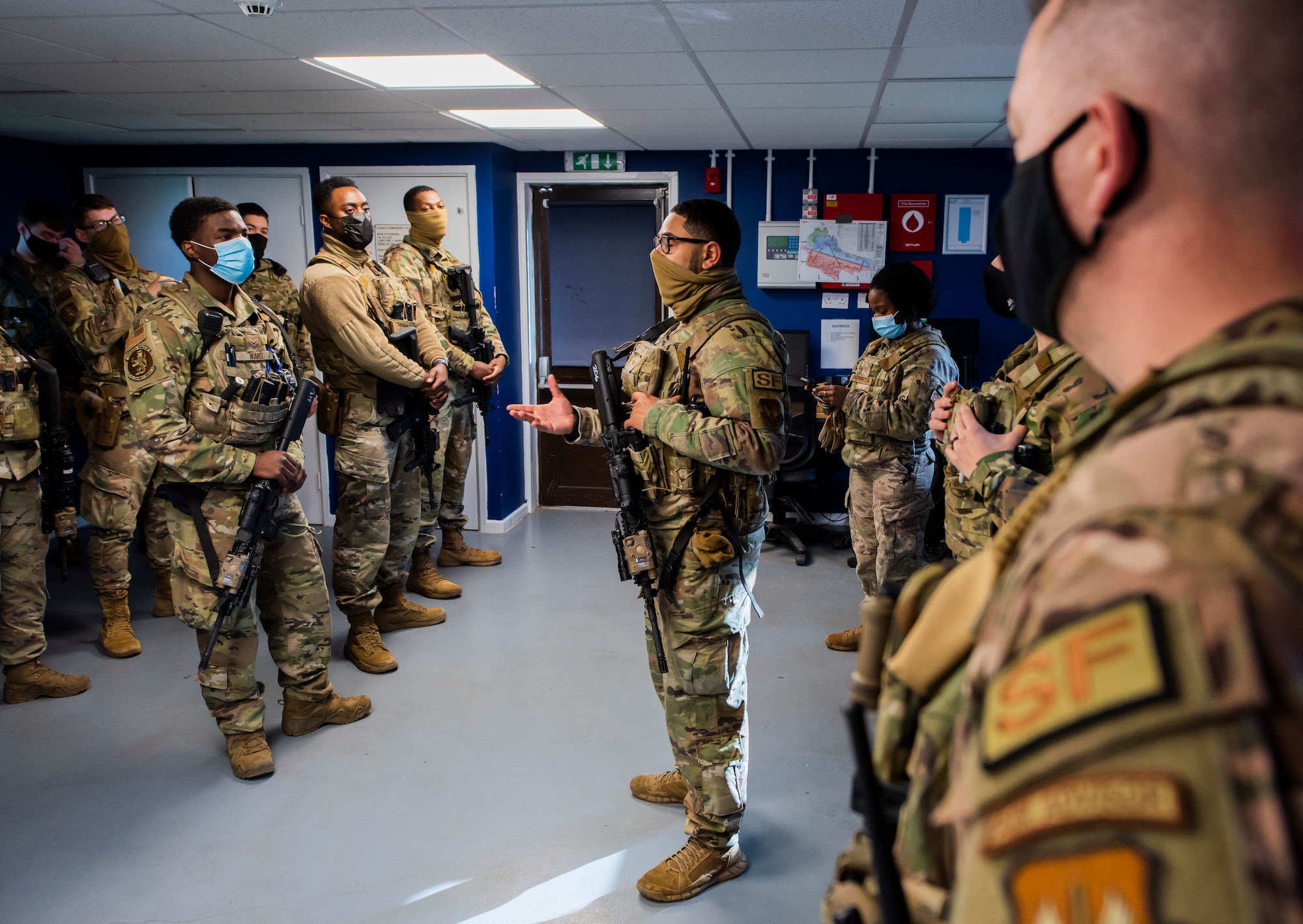 A member of the 100th Security Forces Squadron shares critical safety information with other members of the 100th SFS Charlie flight during guard mount at Royal Air Force Mildenhall, England, Feb. 17, 2022. Guard mount not only provides an opportunity for the flight sergeants to brief their team, but it also allows Airmen to share critical information with their peers. (U.S. Air Force photo by Senior Airman Kevin Long)