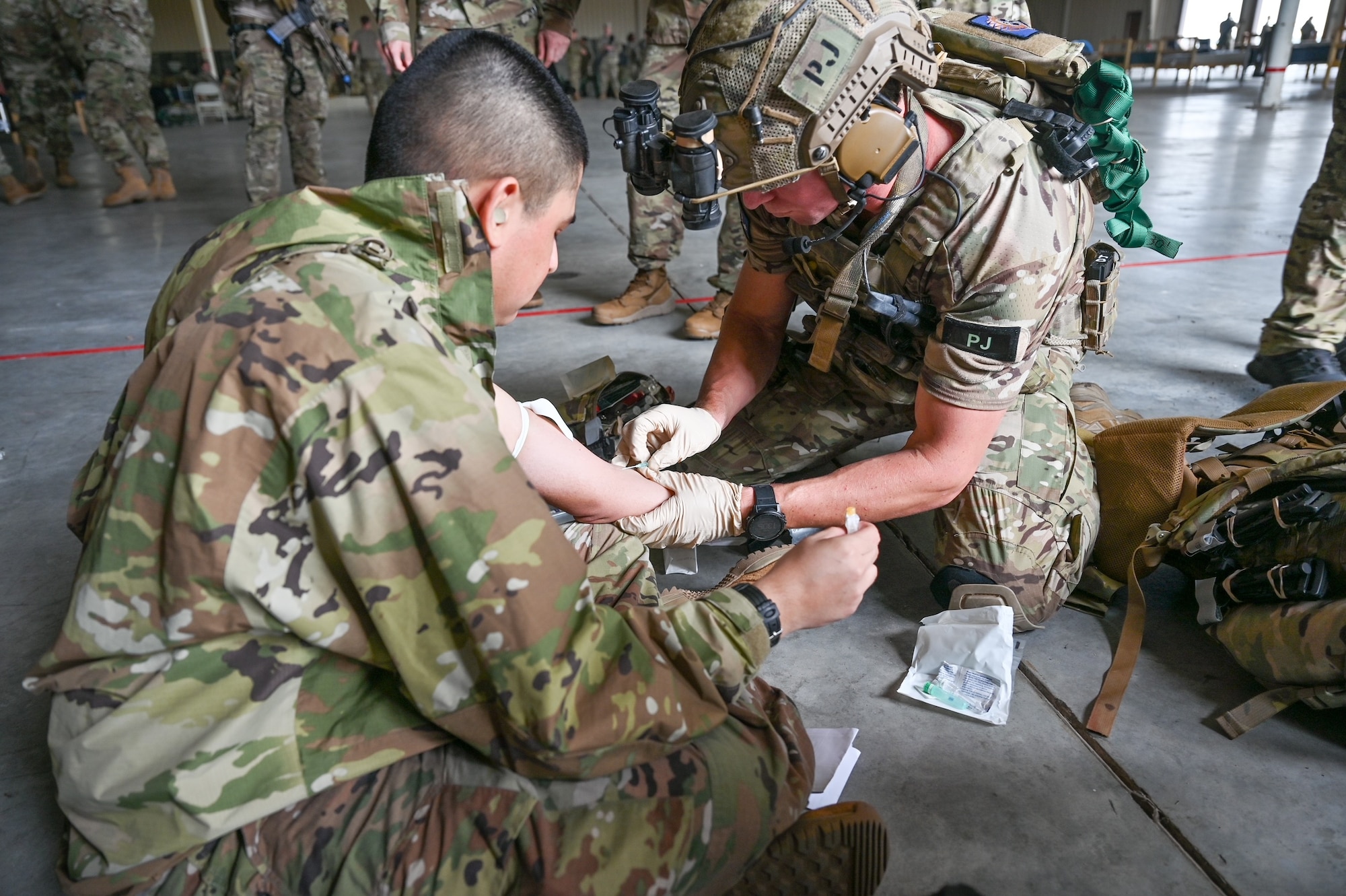 A pararescueman from the 920th Rescue Wing prepares an intravenous line on an Airman during the wing’s FURY HORIZON 22 exercise Feb. 5, 2022. The HORIZON series of wing exercises are held throughout the year at group and wing levels. They bring together the combined knowledge of the entire wing to focus tactics on executing their mission anywhere in the world at a moment’s notice. (U.S. Air Force photo by Capt. Amanda Ling)