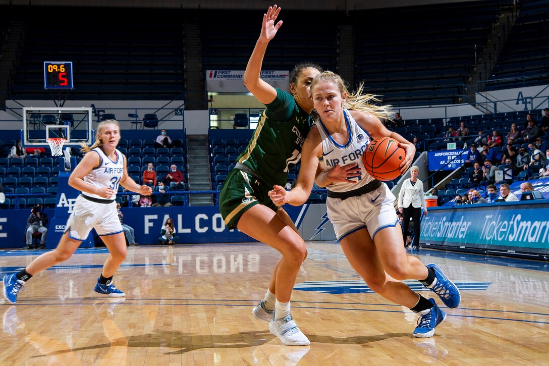 A basketball player drives to the basket during a game.