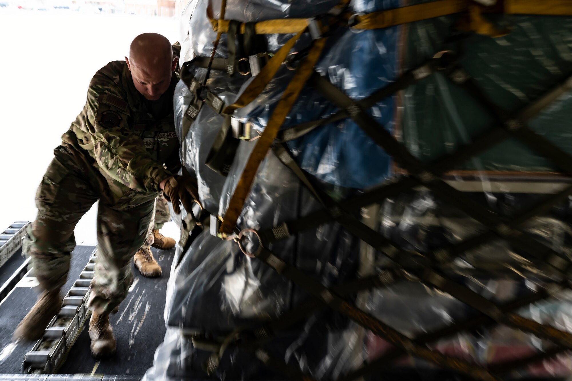 Master Sgt. Justin Tamburro, 32nd Aerial Port Squadron fleet services flight chief, loads cargo for the Department of Defense's Denton Program onto a C-17 Globemaster III at the Pittsburgh International Airport Air Reserve Station, Pennsylvania, Feb. 16, 2022.