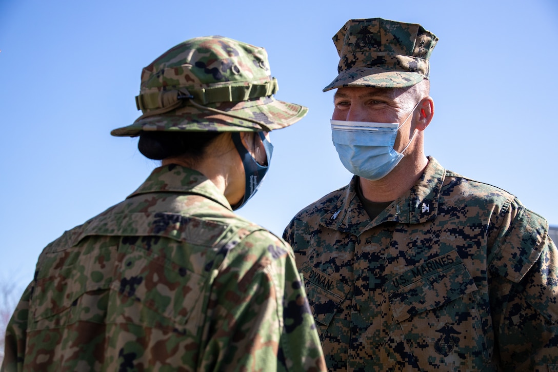 U.S. Marine Corps Col. Sean Dynan, commanding officer of the 15th Marine Expeditionary Unit (MEU), congratulates and gifts a 15th MEU coin to a Japan Ground Self-Defense Force (JGSDF) soldier with 2nd Amphibious Rapid Deployment Regiment for his hard work during the closing ceremony for exercise Iron Fist 2022 at Marine Corps Base Camp Pendleton, California, Feb. 16, 2022. For almost two decades the U.S. Marine Corps, U.S. Navy, and JGSDF have conducted exercise Iron Fist, training together in amphibious operations and affirming the U.S. commitment to our allies. (U.S. Marine Corps photo by Cpl. Aidan Hekker)